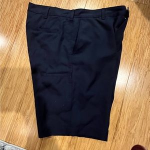 Navy blue flat front golf shorts.